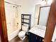 This bathroom has vinyl flooring, a shower/bath combo, and a stylish vanity at 60 Parkman Trl, Covington, GA 30016