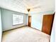 Spacious bedroom with ceiling fan, neutral carpet, and natural light at 60 Parkman Trl, Covington, GA 30016