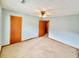 Bright bedroom offers neutral carpeting, ceiling fan and good natural light at 60 Parkman Trl, Covington, GA 30016