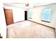 Spacious bedroom with neutral carpet, two windows, and closet at 60 Parkman Trl, Covington, GA 30016