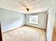 Bright bedroom offers neutral carpeting, ceiling fan and good natural light at 60 Parkman Trl, Covington, GA 30016