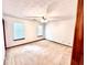 Bright bedroom with neutral carpet, two windows, and ceiling fan at 60 Parkman Trl, Covington, GA 30016
