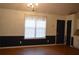 A well-lit dining room features wood-look floors and a chair rail, creating an inviting space for meals at 60 Parkman Trl, Covington, GA 30016