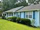 Light blue single story home with blue shutters and a manicured front yard at 60 Parkman Trl, Covington, GA 30016