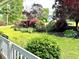 View of front yard with lush green grass and landscaping with colorful flowers from front porch at 60 Parkman Trl, Covington, GA 30016