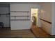 Spacious garage featuring built-in shelving, a ramp, and easy access to the home's utilities at 60 Parkman Trl, Covington, GA 30016
