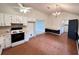 Eat-in kitchen features white cabinets, modern appliances, and stylish blue accents at 60 Parkman Trl, Covington, GA 30016