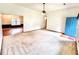 Open living room with view into the next room, carpet, ceiling fan, and natural light at 60 Parkman Trl, Covington, GA 30016