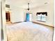 Bright living room with large windows, light carpet, and a ceiling fan at 60 Parkman Trl, Covington, GA 30016