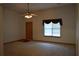 Bright living room featuring neutral carpet, a ceiling fan, and a window bringing in lots of light at 60 Parkman Trl, Covington, GA 30016