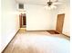 Open-concept living room featuring neutral carpet and a ceiling fan at 60 Parkman Trl, Covington, GA 30016