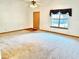 Bright living room featuring light carpet, a ceiling fan, and natural light at 60 Parkman Trl, Covington, GA 30016