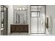 Bathroom with double vanity, decorative mirror, and glass-enclosed shower at 0 Paige St, Dallas, GA 30157