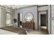Bedroom with wood floors, a round mirror, art, and elegant lighting at 0 Paige St, Dallas, GA 30157