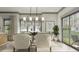 Elegant dining room with a modern chandelier, sliding glass doors, and stylish chairs at 0 Paige St, Dallas, GA 30157