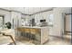 Modern kitchen featuring white cabinetry, granite countertops, stylish pendant lighting, and bar stool seating at 0 Paige St, Dallas, GA 30157