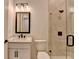 Updated bathroom with single vanity, tile floors, and glass shower enclosure with sleek, black trim at 2750 Herrington Dr, Cumming, GA 30041