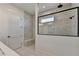 Elegant shower with gray marble tile, rain shower head, bench and glass enclosure at 2750 Herrington Dr, Cumming, GA 30041