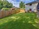 Large backyard featuring a manicured lawn and wooden privacy fence at 3215 Woodview Se Dr, Smyrna, GA 30082