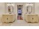Bathroom featuring dual vanities, patterned wallpaper, and a view into the main bedroom at 3215 Woodview Se Dr, Smyrna, GA 30082