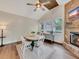 Elegant dining area featuring a fireplace, hardwood floors, and a modern ceiling fan at 3215 Woodview Se Dr, Smyrna, GA 30082