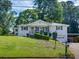 Inviting home with a spacious front yard, attached garage, and classic design at 3215 Woodview Se Dr, Smyrna, GA 30082