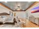 Bright main bedroom with a ceiling fan, wooden beams, and an entertainment center on hardwood floors at 3215 Woodview Se Dr, Smyrna, GA 30082