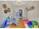 Fun playroom area with colorful mats, a small slide, and direct access to the living room at 3215 Woodview Se Dr, Smyrna, GA 30082