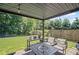 Covered patio features string lights, outdoor seating, and a view of the lawn at 5575 Hedge Brook Dr, Cumming, GA 30028