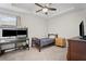 Comfortable bedroom with desk area, ceiling fan and abundant natural light at 5575 Hedge Brook Dr, Cumming, GA 30028