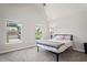 Sunlit bedroom showcases two windows and neutral decor at 5575 Hedge Brook Dr, Cumming, GA 30028