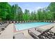 Large community pool surrounded by lounge chairs offering a relaxing place to enjoy in this neighborhood at 5575 Hedge Brook Dr, Cumming, GA 30028