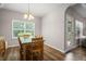 Bright dining area with hardwood floors, large window, and access to outdoor living space at 5575 Hedge Brook Dr, Cumming, GA 30028