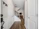 Bright foyer with hardwood floors, white wainscoting, and staircase with black iron spindles at 5575 Hedge Brook Dr, Cumming, GA 30028