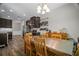 Spacious kitchen with stainless appliances, dark wood cabinets, and adjacent dining area with ample seating at 5575 Hedge Brook Dr, Cumming, GA 30028