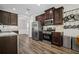 Modern kitchen featuring stainless steel appliances, granite countertops, and dark wood cabinetry at 5575 Hedge Brook Dr, Cumming, GA 30028