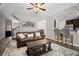 Open-concept living room features hardwood floors and seamless transition to kitchen and staircase at 5575 Hedge Brook Dr, Cumming, GA 30028