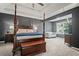 Spacious main bedroom boasts a four-poster bed, sitting area and tray ceiling at 5575 Hedge Brook Dr, Cumming, GA 30028