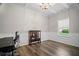Refined home office with hardwood floors, wainscoting, and a large window at 5575 Hedge Brook Dr, Cumming, GA 30028