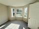 Bedroom with three bright windows and carpeted floor at 7097 Cavender Sw Dr, Atlanta, GA 30331