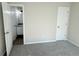 Neutral carpeted bedroom with white door to bathroom, and additional closet at 7097 Cavender Sw Dr, Atlanta, GA 30331