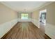 Spacious dining room with wood floors, wainscoting, a window, and chandelier at 7097 Cavender Sw Dr, Atlanta, GA 30331