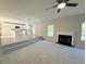 Spacious living room seamlessly flows into a kitchen, complete with plush carpeting and a fireplace at 7097 Cavender Sw Dr, Atlanta, GA 30331