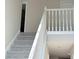 Carpeted staircase featuring a white banister at 7097 Cavender Sw Dr, Atlanta, GA 30331