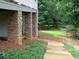 Home's backyard with stone pillars and landscaped walking path at 21 Devin Lane Ln, Euharlee, GA 30145