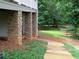 Exterior view of a backyard with stone columns, a manicured lawn, and a wooden fence at 21 Devin Lane Ln, Euharlee, GA 30145