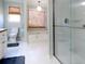 Bright bathroom featuring tiled floors, a glass-enclosed shower, and a large soaking tub at 21 Devin Lane Ln, Euharlee, GA 30145