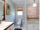 Bathroom with a window with woven shade, vanity sink and toilet at 21 Devin Lane Ln, Euharlee, GA 30145