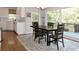 Bright dining room with hardwood floors, table set, and a view of the back deck through large windows at 21 Devin Lane Ln, Euharlee, GA 30145