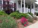 Charming front porch view with beautiful landscaping, flowers and a Japanese maple at 21 Devin Lane Ln, Euharlee, GA 30145